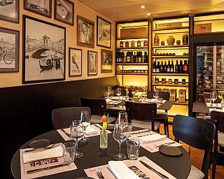 Gemütliche Restaurantatmosphäre mit stilvollem Interieur und Weinregal.